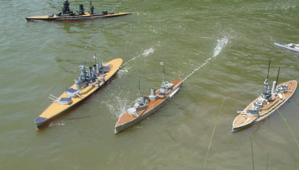 several model warships engaged in combat